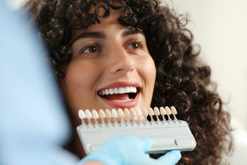 What is the difference between teeth bonding and veneers?