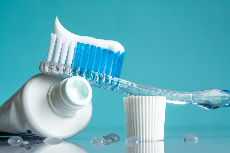toothbrush with fluoride toothpaste for cavity protection close up