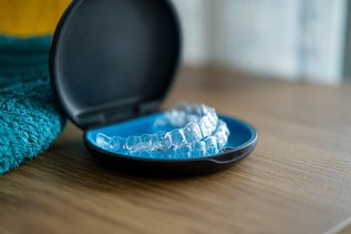 Invisalign clear aligners on teeth close-up