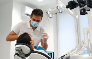 Dentist discussing Canadian Dental Care Plan CDCP coverage and treatment options with a patient during a dental consultation.