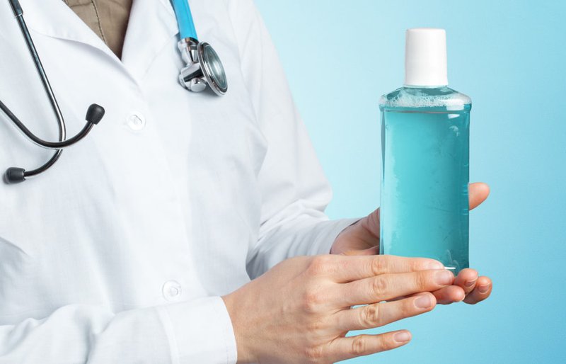 Dentist explaining the use of hydrogen peroxide mouthwash