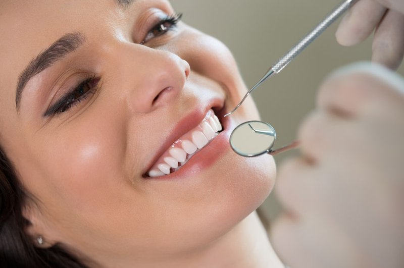 Fluoride varnish is being applied to teeth during a dental cleaning