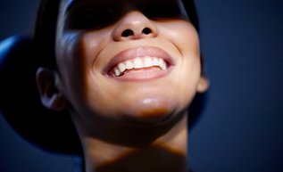 Patient smiling after professional teeth whitening treatment at Smile By Design in North York Toronto